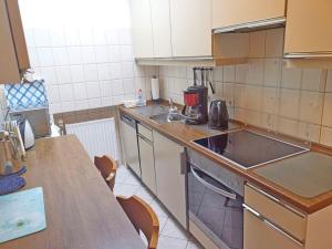 a small kitchen with a sink and a counter at Ferienwohnung Haus Waldesrand in Norderney +4 photos