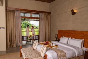 Letto o letti in una camera di Sanctuary Chitwan National Park