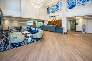 a lobby with couches and chairs in a building at Comfort Inn & Suites in Ingersoll