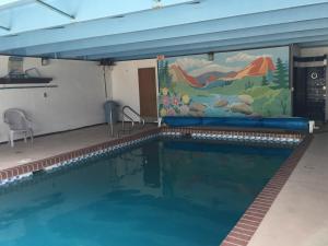 a swimming pool with a mural on the wall at Garden of the Gods Motel in Colorado Springs