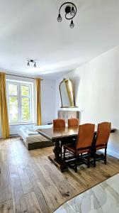 a living room with a table and chairs and a bed at Pawia Apartments Centrum in Krakow