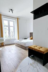 a bedroom with a bed and a large window at Pawia Apartments Centrum in Krakow