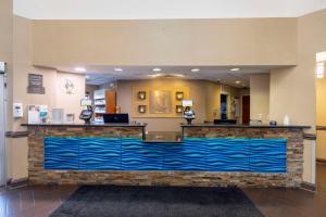 a large lobby with a large blue counter at Comfort Suites Springfield in Springfield