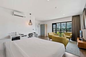 a hotel room with a bed and a living room at The Kingsford Brisbane Airport, Ascend Hotel Collection in Brisbane