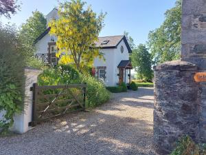 a gate in front of a white house at Bellfry at Old Boley in Wexford
