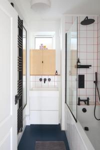 a bathroom with a sink and a shower at Modern Apartment on London's Southbank in London