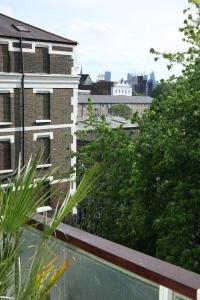 a view of the city from the balcony of a building at Modern Apartment on London's Southbank in London