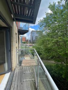 a balcony with a wooden bench on a building at Remarkable 2-Bed Apartment in Leeds in Leeds