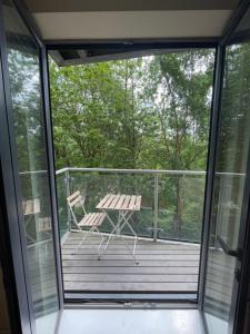 a patio with a table and a chair on a deck at Remarkable 2-Bed Apartment in Leeds in Leeds