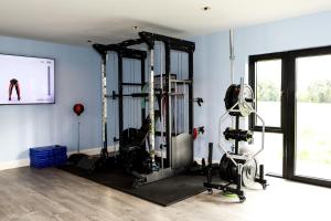 a gym with two treadmills and a treadmill at 5* Self Catering in Nenagh