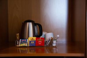 a coffee pot and other items on a table at Best Western Hotel Santa Caterina in Acireale