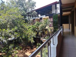 a balcony of a building with trees and bushes at Victory Inn Monaragala in Monaragala