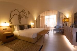 a bedroom with a bed and a living room at Liwa Hotel in Mezairaa +37 photos