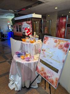 a table with a sign and some food on it at Hotel Fantacy (Adult Only) in Hamamatsu