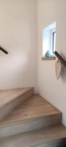 a staircase in a room with wooden floors and a window at Ferienhaus Leoni in Rieden