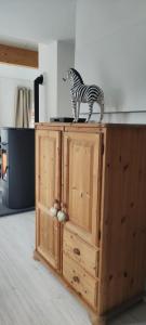 a zebra statue standing on top of a wooden cabinet at Ferienhaus Leoni in Rieden