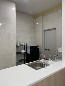 a kitchen with a sink and a counter top at Putrajaya AQ Homestay (Near PICC) in Putrajaya