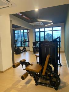 a room with a gym with several exercise equipment at Putrajaya AQ Homestay (Near PICC) in Putrajaya