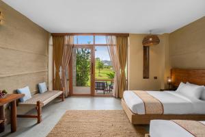 Letto o letti in una camera di Sanctuary Chitwan National Park