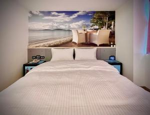 A bed or beds in a room at Good Time Boutique Hotel