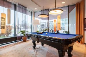 a pool table in a room with windows at Best Western Plus Park City Lund in Lund