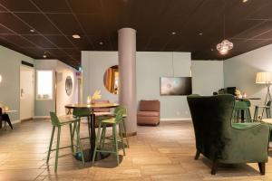 a room with chairs and a table and a table and chairs at Best Western Plus Park City Solna in Solna