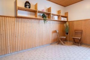 a room with two chairs and a wooden wall at Best Western Plus Park City Solna in Solna
