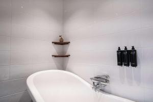 a white bathroom with a toilet and a sink at Best Western Plus Park City Solna in Solna