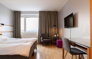 a hotel room with a bed and a desk at Best Western Plus Park City Solna in Solna