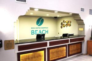 a bar with the logo of a beach restaurant at Boca Suites Deerfield Beach; SureStay Collection by BW in Deerfield Beach