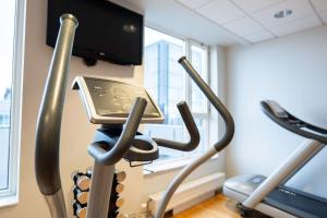 a treadmill in a gym with a tablet on it at Best Western Plus Park City Malmö in Malmö