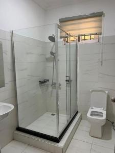 a bathroom with a shower and a toilet at Wyndham Villa in Ogbojo