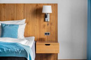 a bedroom with a bed and a night stand with a lamp at Best Western Plus Park Globetrotter Copenhagen Airport in Copenhagen