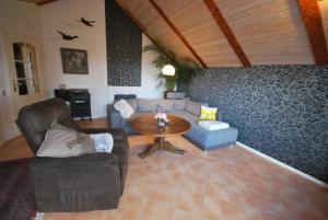 a living room with a couch and a table at Ferienhaus Eichenhof 35648 in Uplengen