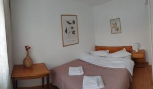 a bedroom with a bed with two towels on it at Azuga Apartament Super View & Ski in Azuga