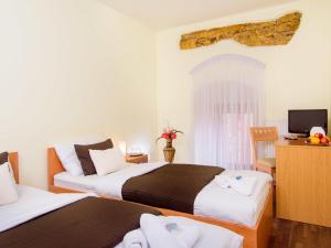 Postel nebo postele na pokoji v ubytování Hotel STARÝ PIVOVAR