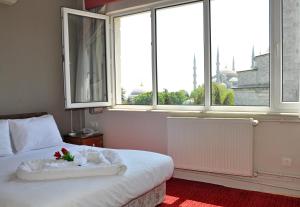 a bedroom with a bed with a flower on it at No20 Hotel Sultanahmet in Istanbul