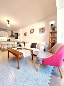 a living room with a couch and a table and chairs at Agua Marina in Playa Honda