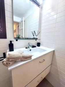 a bathroom with a sink and a mirror at Agua Marina in Playa Honda