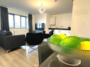 a living room with a bowl of fruit on a table at Rosebank Court by Blue Skies Stays in Stockton-on-Tees