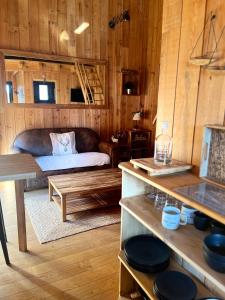 - un salon avec un canapé et une table dans l'établissement La cabane du Broustic, à Andernos-les-Bains