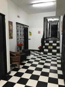a lobby with a black and white checkered floor at 310 Guest House La Vyda in San Juan