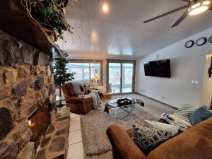 a large living room with a stone wall at Home away from home. in Wisconsin Dells