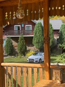 a car parked in front of a house at Casa Morar in Valea Drăganului