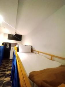 Postel nebo postele na pokoji v ubytování New Mango Dormitory