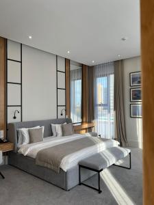 a bedroom with a large bed and a large window at NEOS HOTEL in Astana