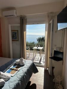 a bedroom with a bed and a view of a balcony at Vladimiros Apartments in Barbati