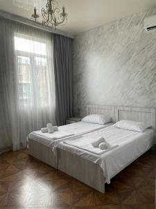 a bedroom with a large bed and a window at Emilia in Batumi +27 photos