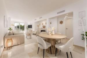 un soggiorno con tavolo e divano di Gorgeous renovated Apt near golf and sea RDR373 a Marbella