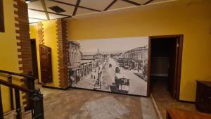 a hallway with a painting of a street on the wall at Hostel Jan in the very center in Yerevan